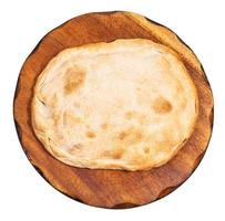 top view of closed flat pie on wooden board photo