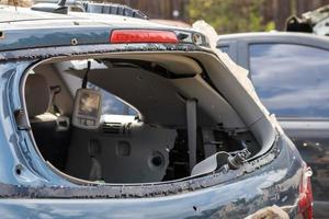 A car after an accident with a broken rear window. Broken window in a vehicle. The wreckage of the interior of a modern car after an accident, a detailed close-up view of the damaged car. photo