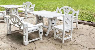 White outdoor wooden chair and table retro style at lawn coffee shop photo