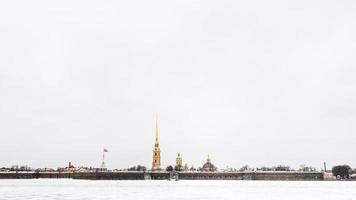gray sky over frozen Neva river and Fortress photo