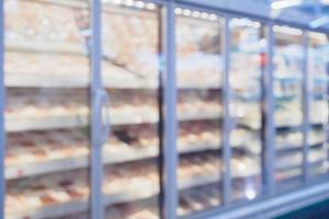 refrigerator shelves with meat in supermarket blur background photo