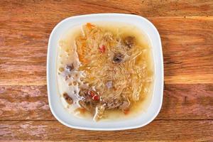 cabbage soup with stewed sauerkraut in white plate photo