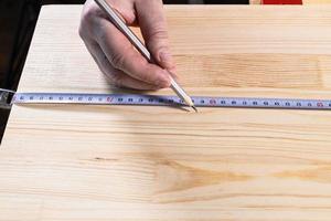 front view of hand of carpenter with pencil photo