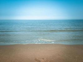 Beach with calm sea and horizon photo