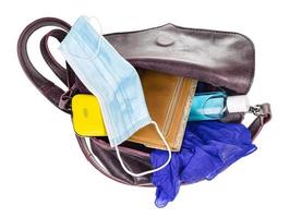 top view of woman's bag with protective mask photo