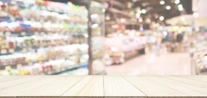 Wood table top with supermarket grocery store blurred defocused background with bokeh light photo