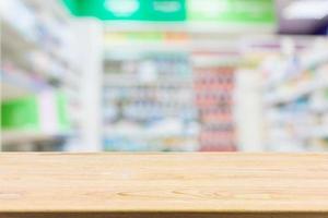 Pharmacy drugstore counter table with blur abstract backbround with medicine and healthcare product on shelves photo