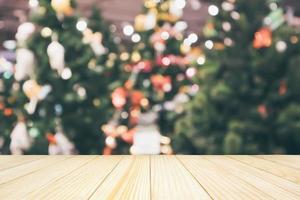 Wood table top with abstract christmas holiday festive bokeh light on tree blurred background for montage product display