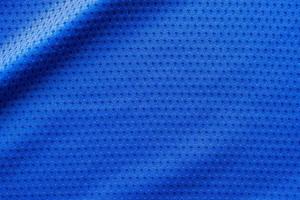 Blue color fabric sport clothing football jersey with air mesh texture background photo