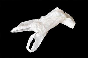 white plastic bag isolated on black background photo