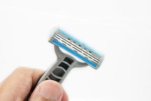 Hand with shaving razor isolated on a white background photo