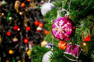 Decorated Christmas tree with colorful bauble on sparkling bokeh light blurred background photo
