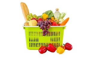 Fresh fruits and vegetables grocery product in green shopping basket isolated on white background photo