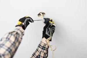 electrician repairing electrical wiring of lamp photo