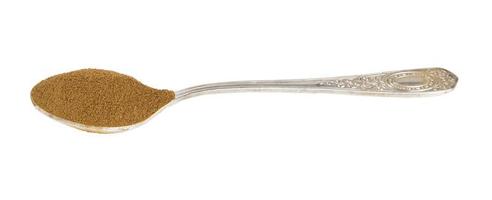 side view of ground roasted chicory root in spoon photo