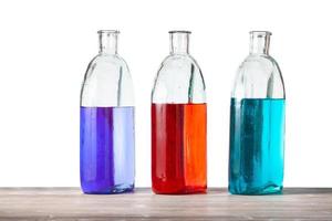 glass bottles with color ink solutions isolated photo