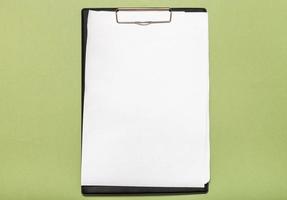 top view of clipboard with blank white paper sheet photo