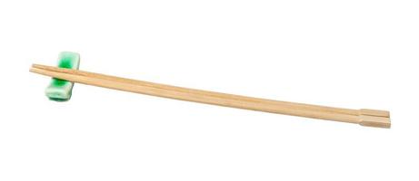 side view of beech chopsticks served on rest photo