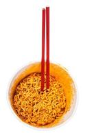 red chopsticks in cup with cooked spicy noodles photo