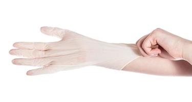 top view of hand wears latex glove on another hand photo