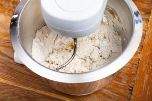 kitchen processor kneads dough with egg photo