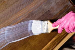 hand varnishes stained a pine furniture board photo