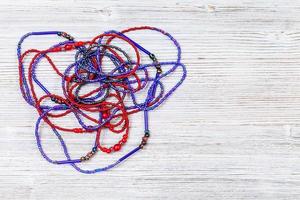 tangled necklace from glass beads on gray photo