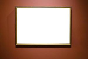 narrow bronze picture frame on brown wall photo