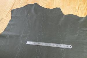 steel ruler on leather with drawn pattern at table photo