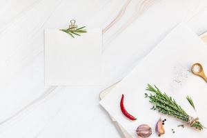 Blank notepad pages with greens herbs and spices photo