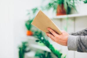 Young man reading open old paper book photo