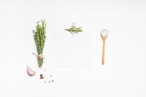 Blank notepad pages with greens herbs and spices photo