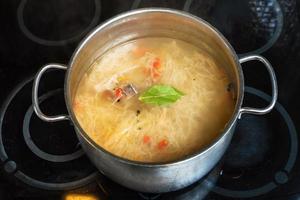 soup from stewed sour cabbage in stockpot photo