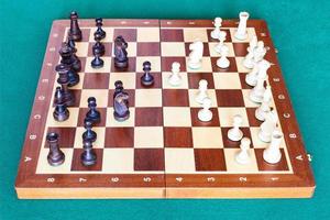 side view of chess gameplay on wooden chessboard photo