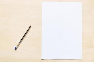 bolígrafo de plástico y hoja en blanco de papel de oficina blanco foto