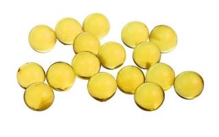 yellow capsules with oil isolated on white photo