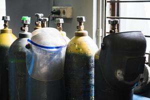 gas cylinders and protection mask in workshop photo
