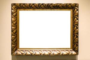 old carved wide bronze picture frame on brown wall photo