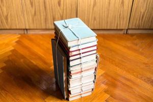 above view of stack of old books tied with twine photo