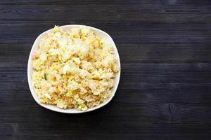 top view of Fried Rice in bowl on dark table photo