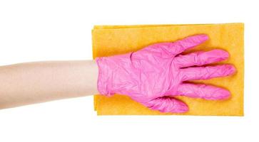 hand in pink glove holds flat yellow rag isolated photo