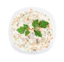 portion of Olivier salad with leaf of parsley photo