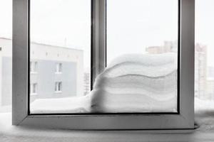 snowdrift between windowpanes in winter photo