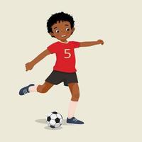 cute little African boy playing soccer kicking the football to make a goal vector