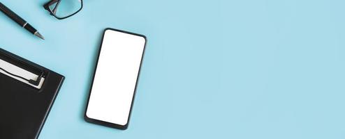 Empty screen Smart phone and file folder on business desk office with copy space, Top view photo