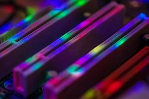 Abstract background with neon light on computer processing equipment photo