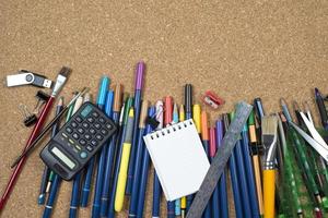 various stationery, arranged on the underside of a cork photo