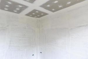 Empty room interior with gypsum board ceiling at construction site photo