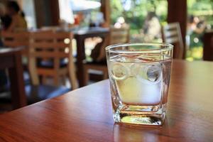 glass of water on wood table in restaurant photo