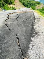 asphalt road cracked and broken texture photo